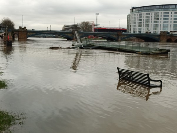 Flooding in Nottinghamshire with a submerged bench in the foreground